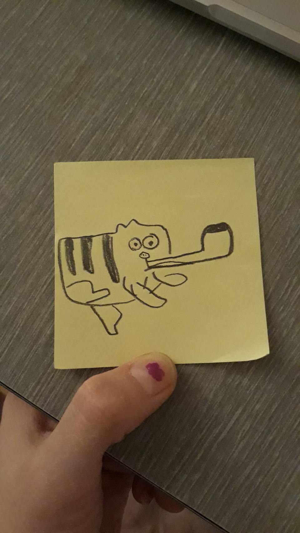 pencil drawing on a post-it note of garf smoking a pipe. the pipe is big and one of his legs is splooted out. it's great